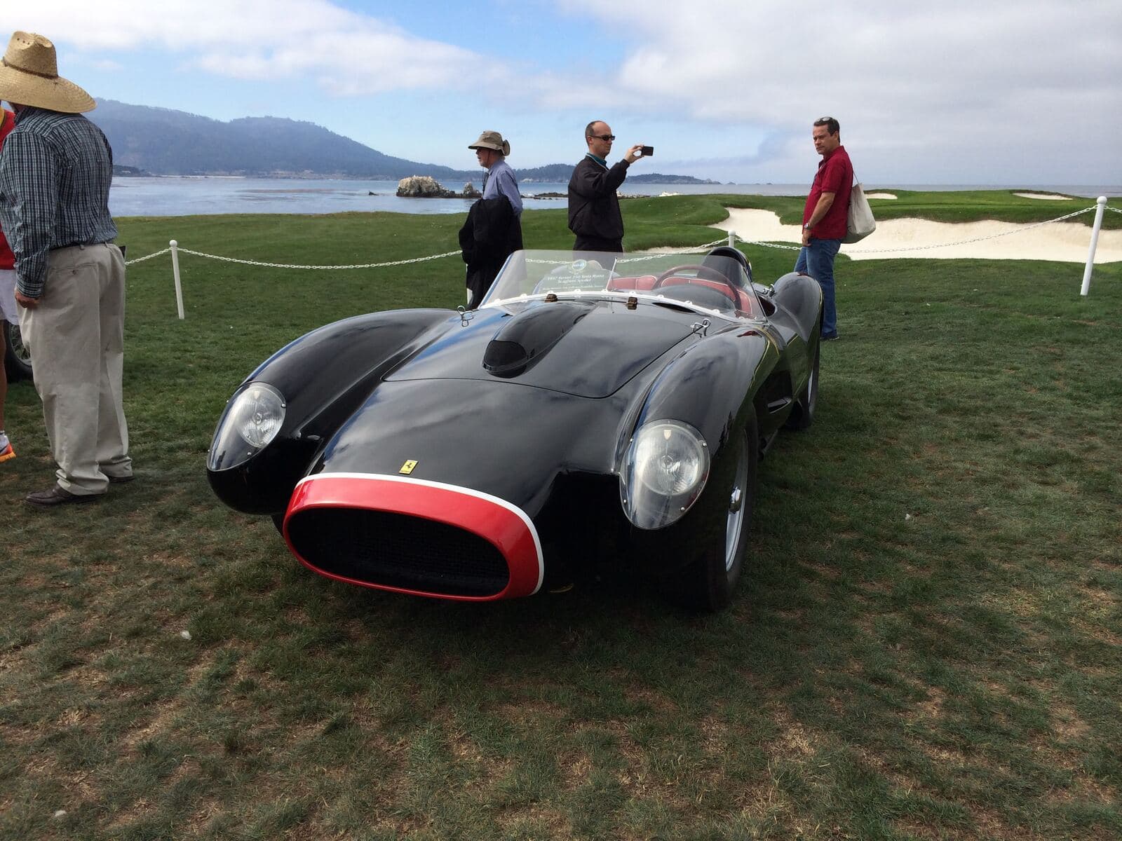 A Ferrari Testa Rossa on the concours lawn at Pebble Beach, ocean beyond