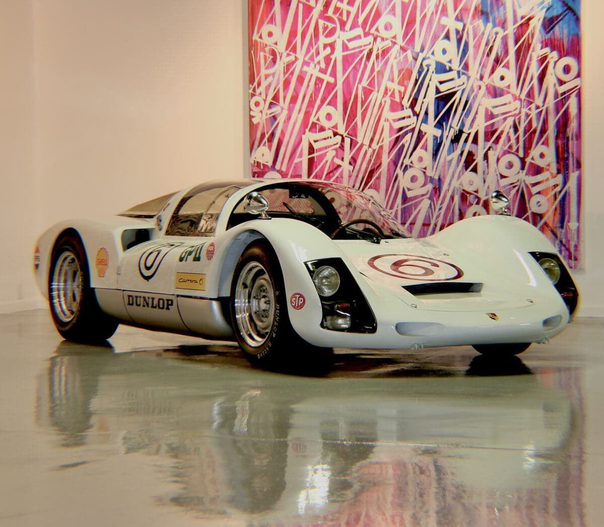 Porsche 906 in front of a large pink RETNA canvas